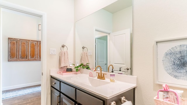 1715 Swale Ln, Granbury, TX 76049 - bathroom featuring vanity, wood finished floors, and baseboards