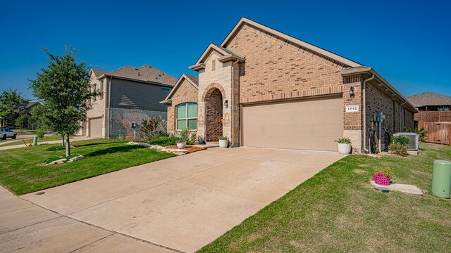 1715 Swale Ln, Granbury, TX 76049 - view of front of property with brick siding, a garage, driveway, and central air condition unit