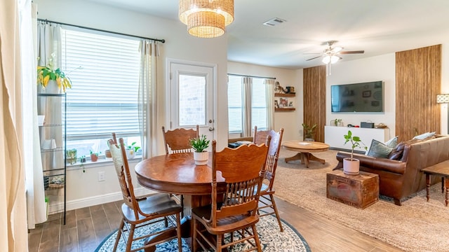 1715 Swale Ln, Granbury, TX 76049 - dining room featuring wood finished floors, a ceiling fan, and a chandelier