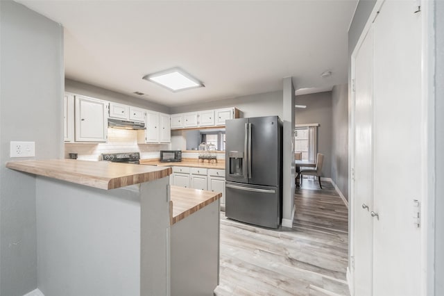 5622 Polo Club Dr, Arlington, TX 76017 - kitchen featuring stainless steel fridge, wooden counters, under cabinet range hood, range with electric stovetop, and white cabinets