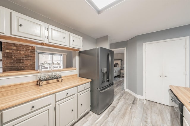 5622 Polo Club Dr, Arlington, TX 76017 - kitchen with appliances with stainless steel finishes, white cabinets, light wood-style floors, and baseboards