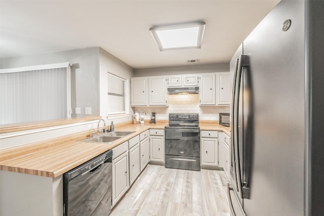 5622 Polo Club Dr, Arlington, TX 76017 - kitchen with black appliances, a sink, under cabinet range hood, light countertops, and light wood-type flooring