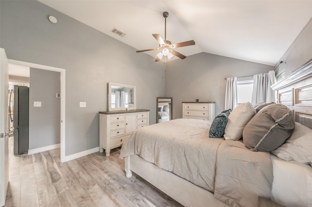 5622 Polo Club Dr, Arlington, TX 76017 - bedroom featuring vaulted ceiling, freestanding refrigerator, light wood-style flooring, multiple windows, and a ceiling fan