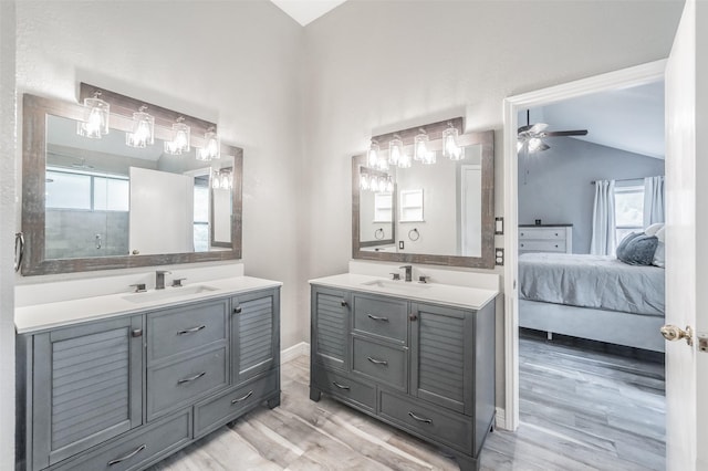 5622 Polo Club Dr, Arlington, TX 76017 - ensuite bathroom featuring vaulted ceiling, two vanities, wood finished floors, a stall shower, and baseboards