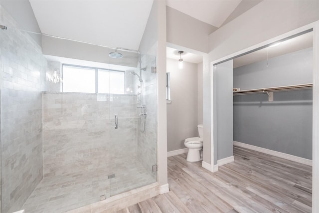 5622 Polo Club Dr, Arlington, TX 76017 - bathroom featuring toilet, a stall shower, vaulted ceiling, a walk in closet, and wood finished floors