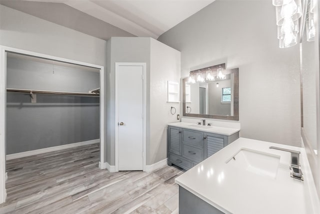 5622 Polo Club Dr, Arlington, TX 76017 - full bath with vanity, a walk in closet, wood finished floors, and baseboards
