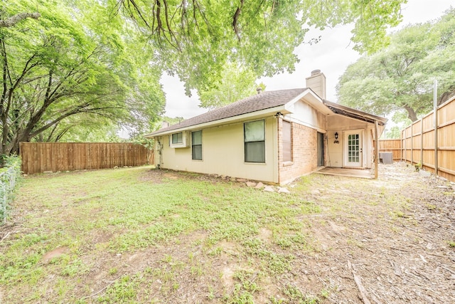 5622 Polo Club Dr, Arlington, TX 76017 - rear view of property with a chimney, cooling unit, a fenced backyard, and roof with shingles