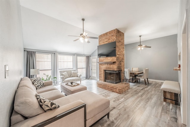 5622 Polo Club Dr, Arlington, TX 76017 - living room featuring a ceiling fan, lofted ceiling, a brick fireplace, light wood-style flooring, and baseboards