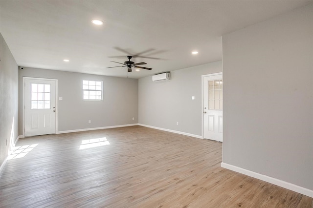 3614 County Road 902, Joshua, TX 76058 - unfurnished living room featuring a wall unit AC, ceiling fan, recessed lighting, baseboards, and light wood-type flooring