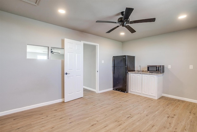 3614 County Road 902, Joshua, TX 76058 - kitchen with freestanding refrigerator, stainless steel microwave, baseboards, light wood-style floors, and recessed lighting