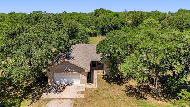 7578 Dick Price Rd, Mansfield, TX 76063 - view of front of property featuring brick siding, a forest view, an attached garage, and driveway
