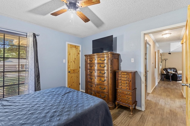 5240 Hill Ridge Dr, Fort Worth, TX 76135 - bedroom with wood finished floors, a textured ceiling, ceiling fan, and baseboards