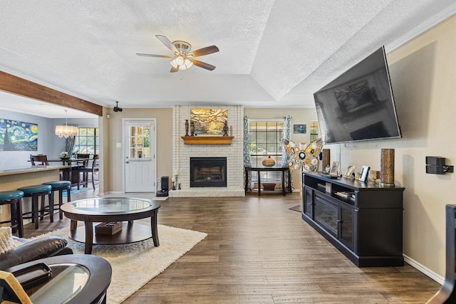 5240 Hill Ridge Dr, Fort Worth, TX 76135 - living area with a ceiling fan, a fireplace, a textured ceiling, healthy amount of natural light, and wood finished floors