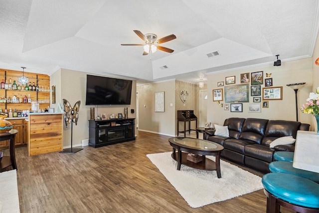 5240 Hill Ridge Dr, Fort Worth, TX 76135 - living area with a ceiling fan, wood finished floors, a tray ceiling, ornamental molding, and a textured ceiling