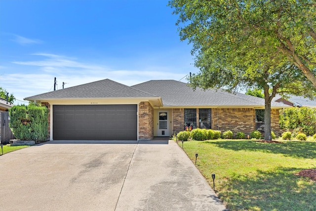 5240 Hill Ridge Dr, Fort Worth, TX 76135 - ranch-style home featuring an attached garage, concrete driveway, a front lawn, brick siding, and roof with shingles