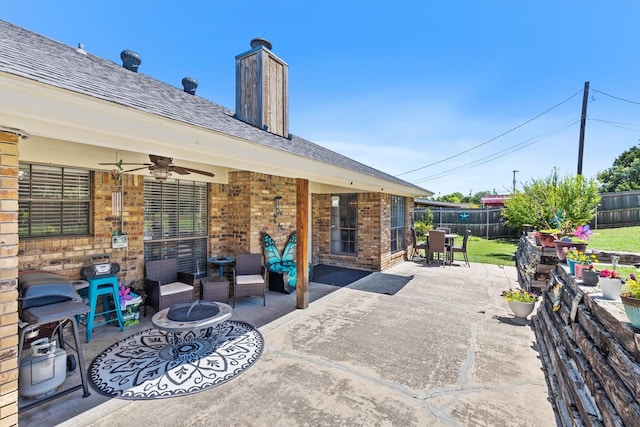 5240 Hill Ridge Dr, Fort Worth, TX 76135 - fenced backyard with ceiling fan, a patio area, and an outdoor living space with a fire pit