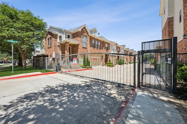 6116 Portrush Dr, Fort Worth, TX 76116 - view of road with a gate, curbs, a residential view, and traffic signs