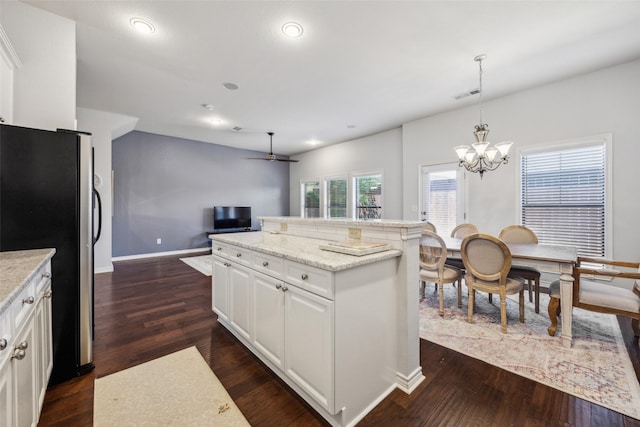 6116 Portrush Dr, Fort Worth, TX 76116 - kitchen featuring freestanding refrigerator, open floor plan, a chandelier, dark wood finished floors, and white cabinets