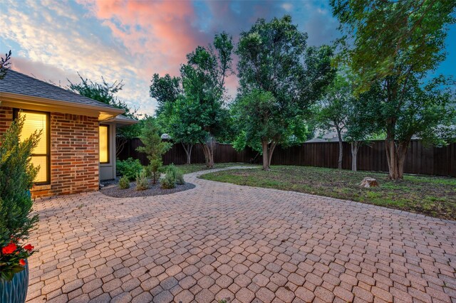 6702 Rolling Vista Dr, Dallas, TX 75248 - patio terrace at dusk with a patio area and a fenced backyard