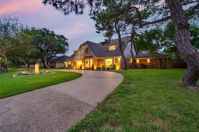 6702 Rolling Vista Dr, Dallas, TX 75248 - english style home with curved driveway, brick siding, and cooling unit