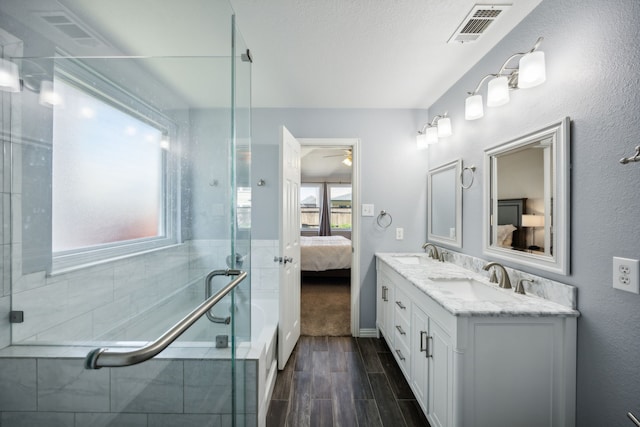 208 Bluefinch, Little Elm, TX 75068 - ensuite bathroom with double vanity, wood finish floors, an enclosed shower, a ceiling fan, and a tub