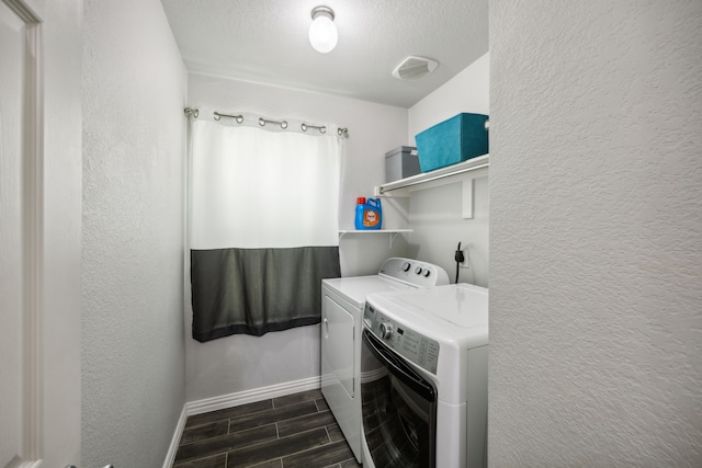 208 Bluefinch, Little Elm, TX 75068 - laundry area featuring washing machine and clothes dryer, baseboards, a textured wall, wood finish floors, and a textured ceiling