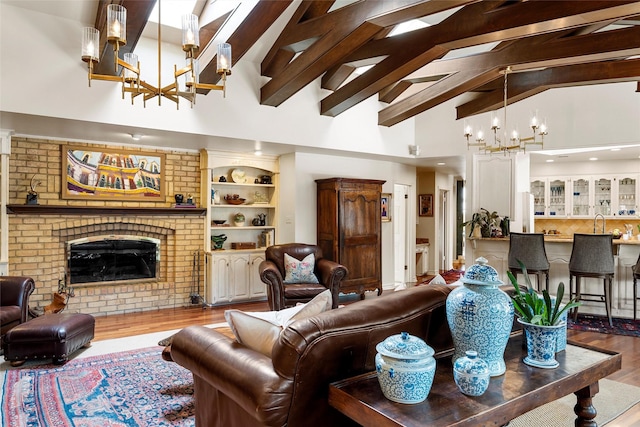3012 Wood Lake Dr, Waco, TX 76710 - living area with a chandelier, wood finished floors, high vaulted ceiling, beam ceiling, and a fireplace