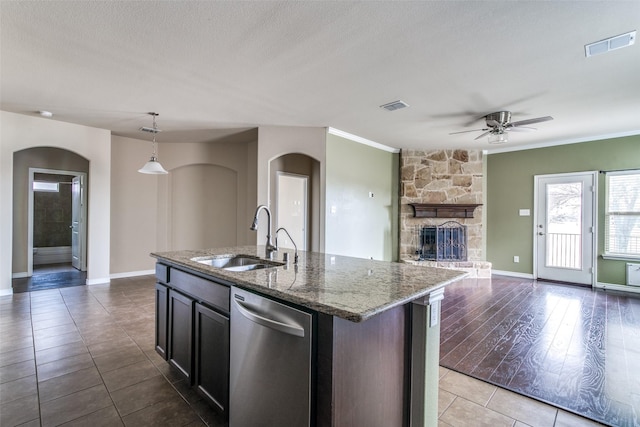 2520 Sabine Cir, Royse City, TX 75189 - kitchen featuring a sink, arched walkways, stainless steel dishwasher, a ceiling fan, and stone countertops