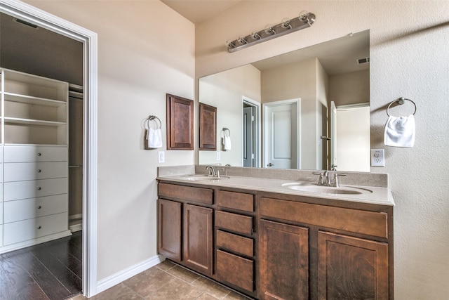2520 Sabine Cir, Royse City, TX 75189 - full bathroom featuring double vanity, baseboards, and a walk in closet