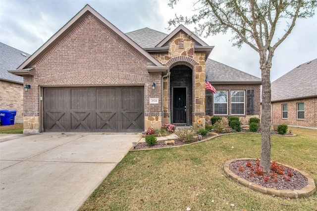 2520 Sabine Cir, Royse City, TX 75189 - view of front facade with brick siding, a garage, stone siding, a shingled roof, and a front lawn