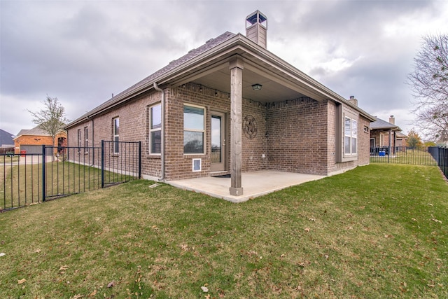 2520 Sabine Cir, Royse City, TX 75189 - rear view of house featuring brick siding, a chimney, and a patio area
