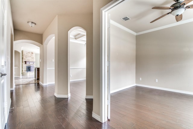 2520 Sabine Cir, Royse City, TX 75189 - foyer featuring a ceiling fan, dark wood-type flooring, arched walkways, ornamental molding, and a fireplace