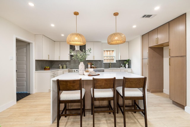 7818 Rolling Acres Dr, Dallas, TX 75248 - kitchen featuring a sink, recessed lighting, decorative backsplash, wall chimney exhaust hood, and light countertops