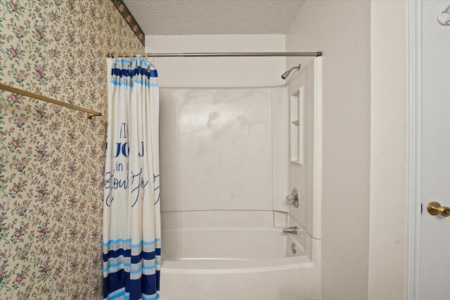 2311 Markland St, Irving, TX 75060 - full bath with shower / bath combo, a textured ceiling, and wallpapered walls