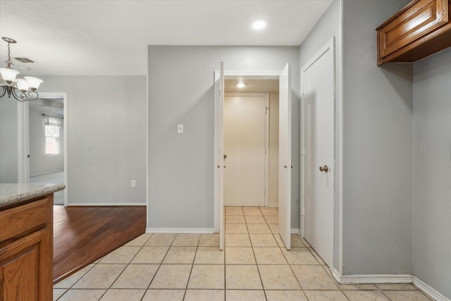 2311 Markland St, Irving, TX 75060 - hallway featuring a chandelier, recessed lighting, light tile patterned floors, and baseboards