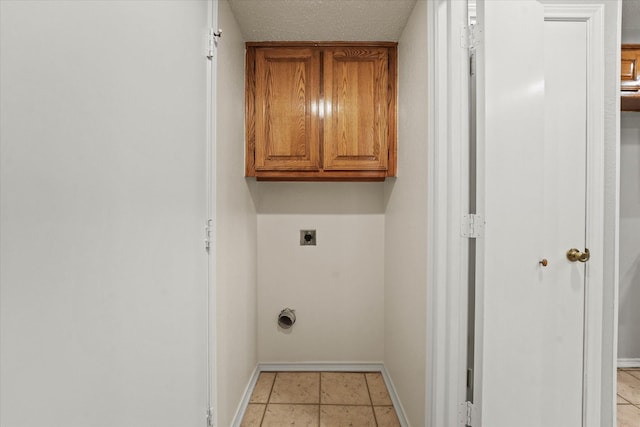 2311 Markland St, Irving, TX 75060 - washroom featuring cabinet space, hookup for an electric dryer, baseboards, and light tile patterned floors