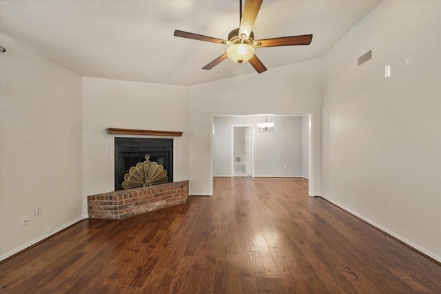 2311 Markland St, Irving, TX 75060 - unfurnished living room with wood finished floors, a ceiling fan, a chandelier, a brick fireplace, and baseboards