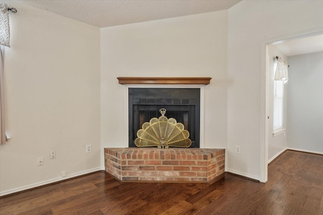 2311 Markland St, Irving, TX 75060 - detailed view of wood finished floors, a brick fireplace, and baseboards