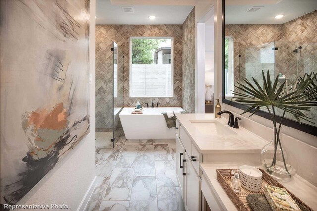 8413 Peach St, Justin, TX 76247 - bathroom featuring a soaking tub, marble look tiles, vanity, and a tile shower