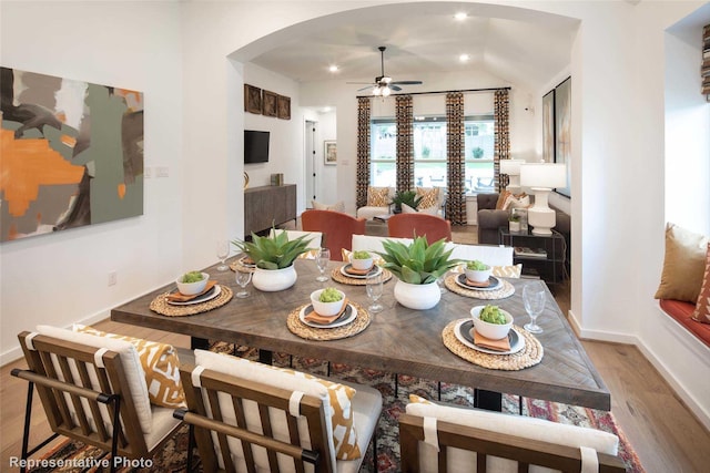 8413 Peach St, Justin, TX 76247 - dining area featuring arched walkways, ceiling fan, wood finished floors, vaulted ceiling, and recessed lighting