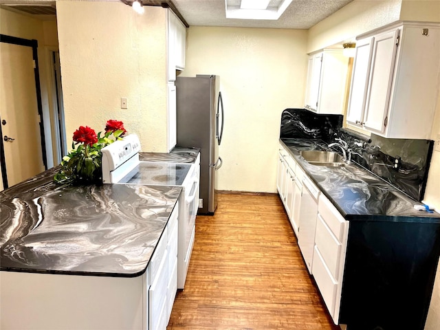 617 Reed St, Roanoke, TX 76262 - kitchen featuring white appliances, a sink, light wood-style floors, and white cabinets
