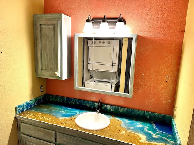 617 Reed St, Roanoke, TX 76262 - bathroom featuring estacked washer and dryer and vanity