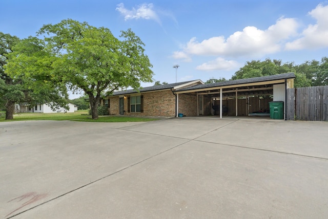 213 Lacewell St, Jacksboro, TX 76458 - view of front of home featuring concrete driveway and a carport