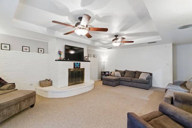 213 Lacewell St, Jacksboro, TX 76458 - carpeted living room with a tray ceiling, a ceiling fan, and a fireplace