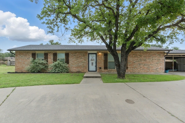 213 Lacewell St, Jacksboro, TX 76458 - ranch-style home with a front yard, brick siding, and a carport