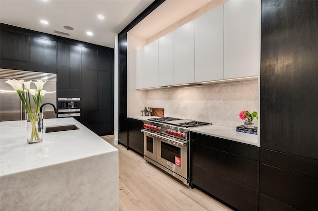6075 Jordan Way, Frisco, TX 75034 - kitchen with premium appliances, dark cabinets, a sink, light countertops, and recessed lighting