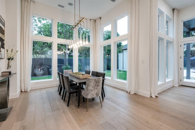 6075 Jordan Way, Frisco, TX 75034 - dining room featuring a high ceiling, light wood-type flooring, and baseboards