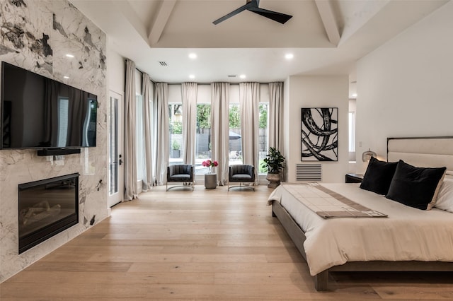 6075 Jordan Way, Frisco, TX 75034 - bedroom featuring light wood-style flooring, beamed ceiling, a premium fireplace, and recessed lighting