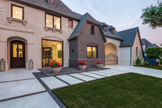 6075 Jordan Way, Frisco, TX 75034 - view of front of home featuring a front yard, a gate, and stone siding