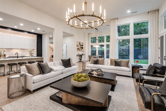 6075 Jordan Way, Frisco, TX 75034 - living area featuring a chandelier, light wood-style flooring, recessed lighting, and a towering ceiling